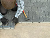 Concrete contractor working on a paver walkway